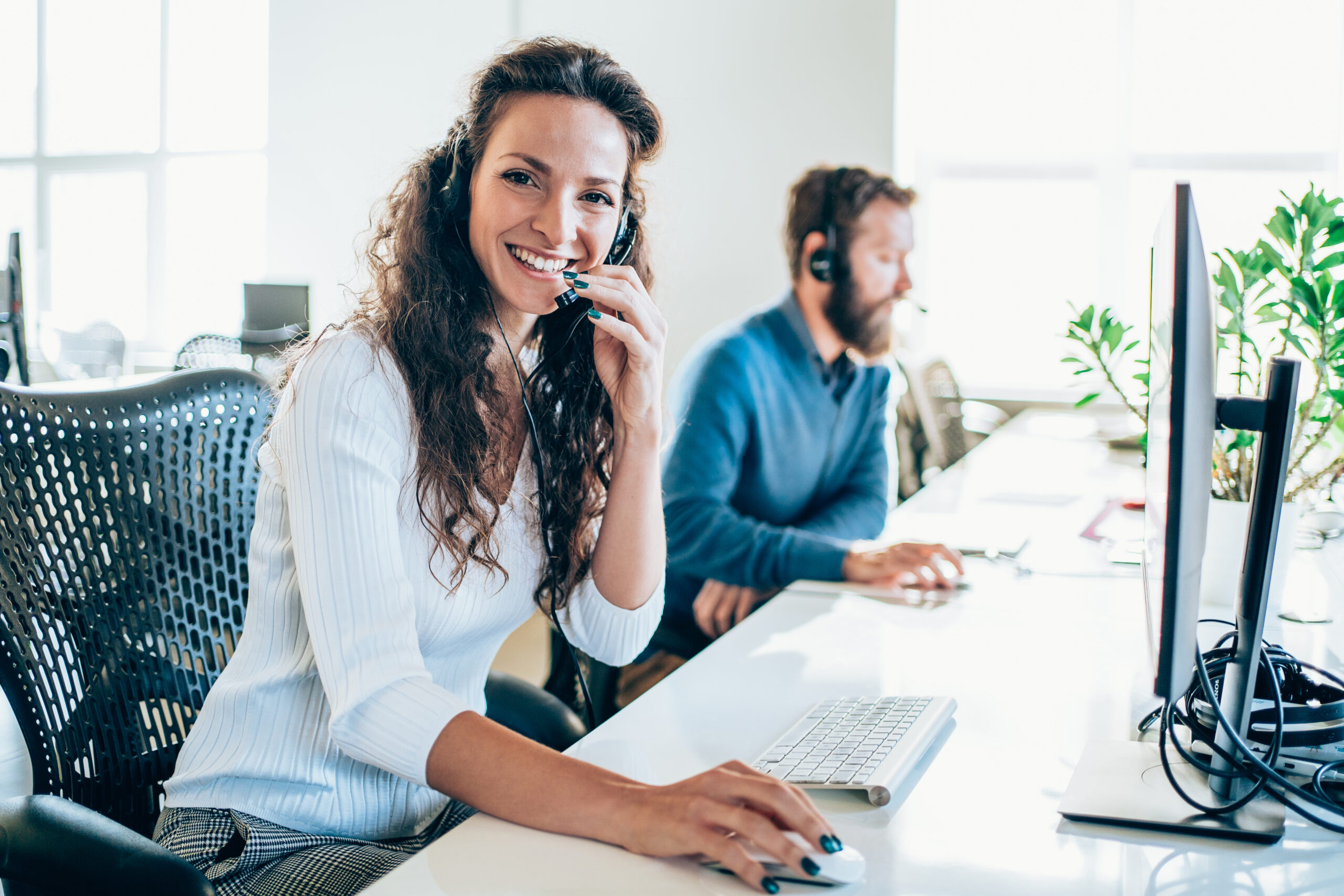 An agent at a call centre assists a customer via VoIP call