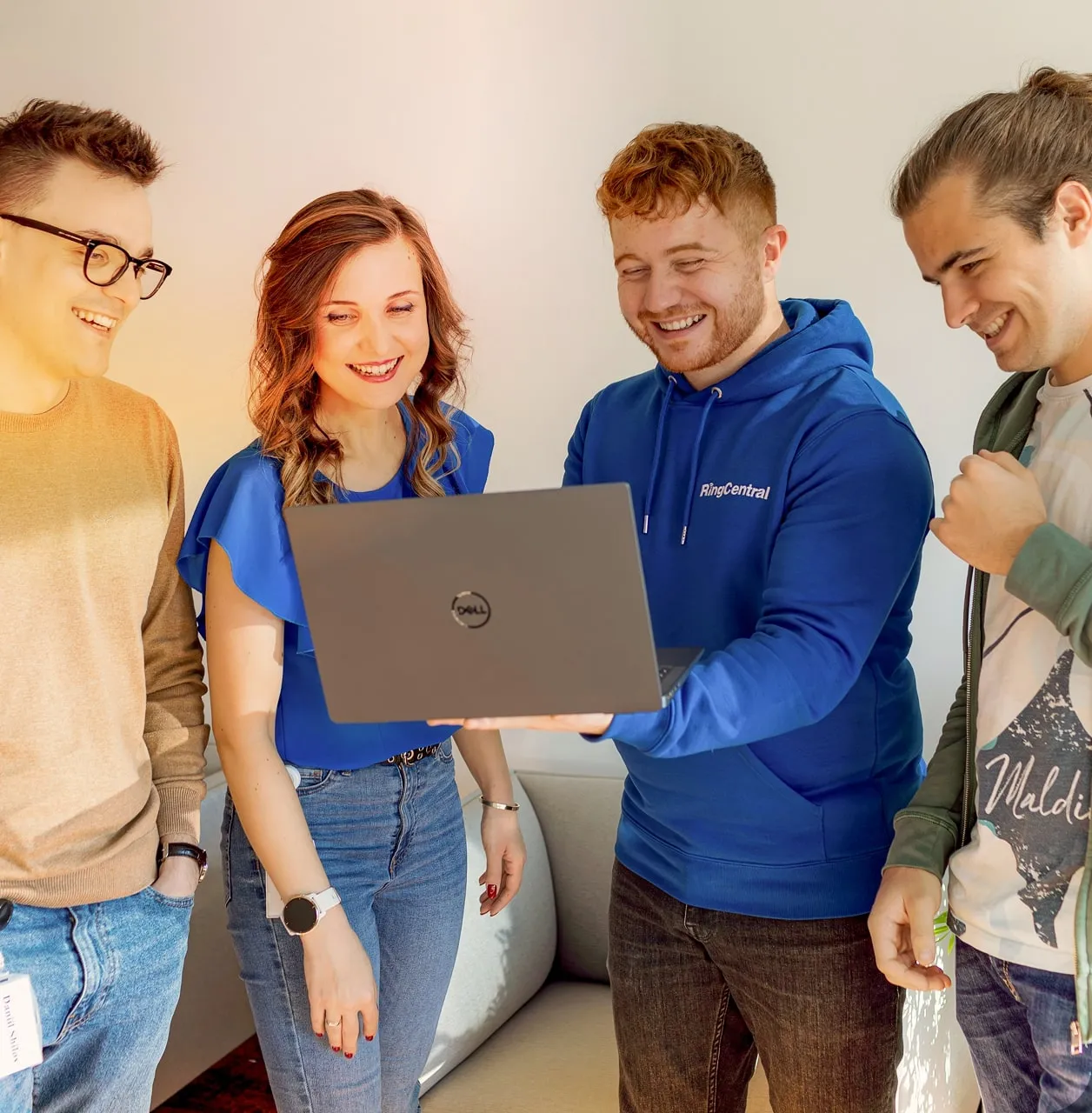 Group of people looking at a laptop.