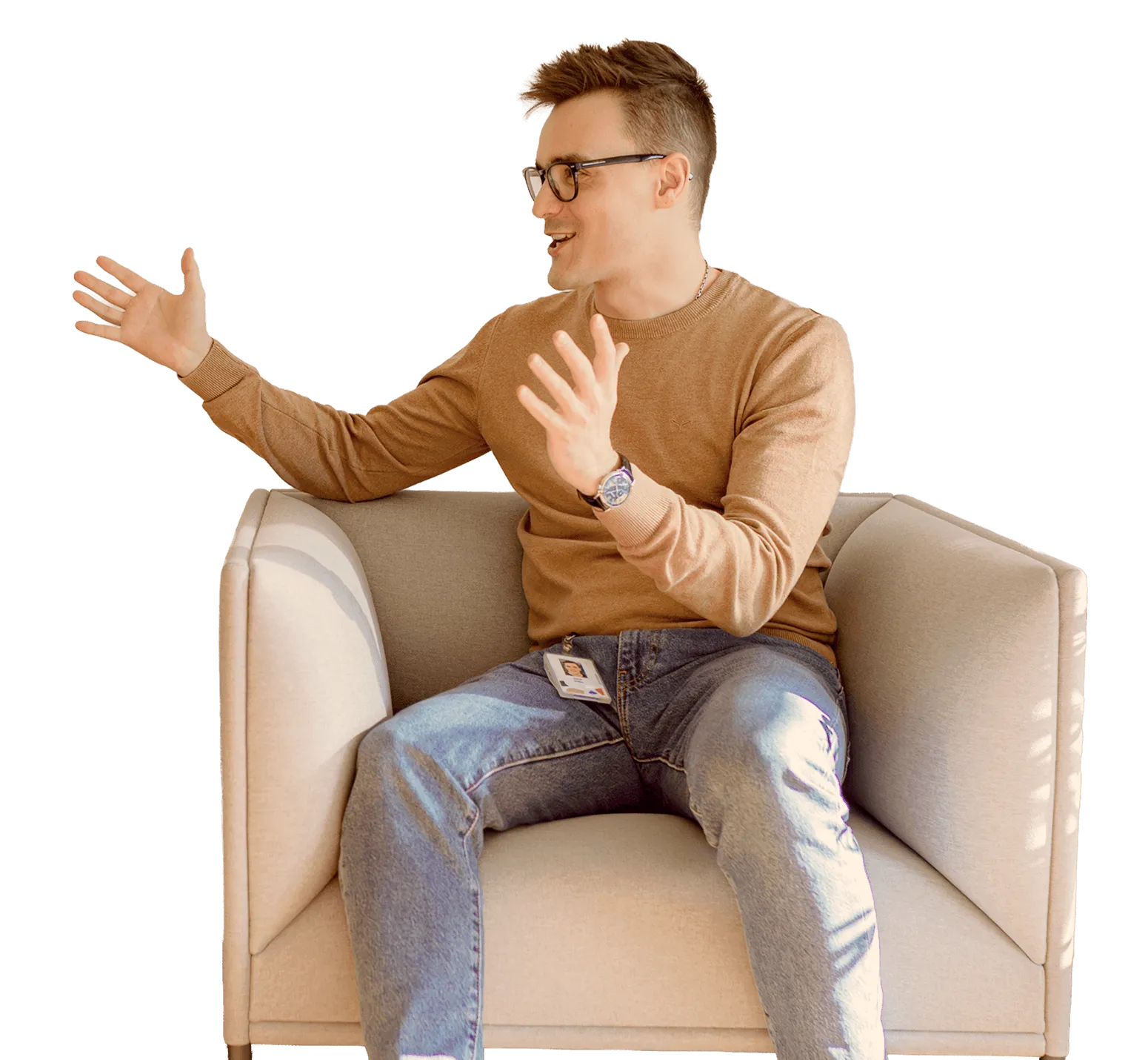 Man sitting in an armchair, gesturing while talking.