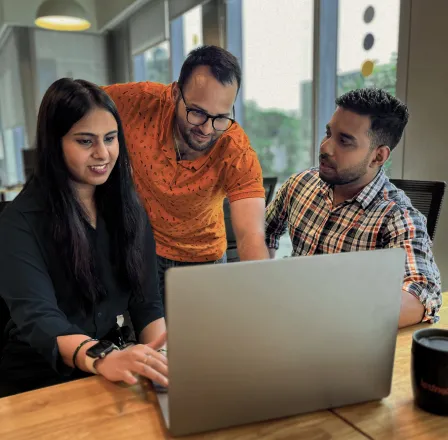 Team members have a happy discussion during an office meeting