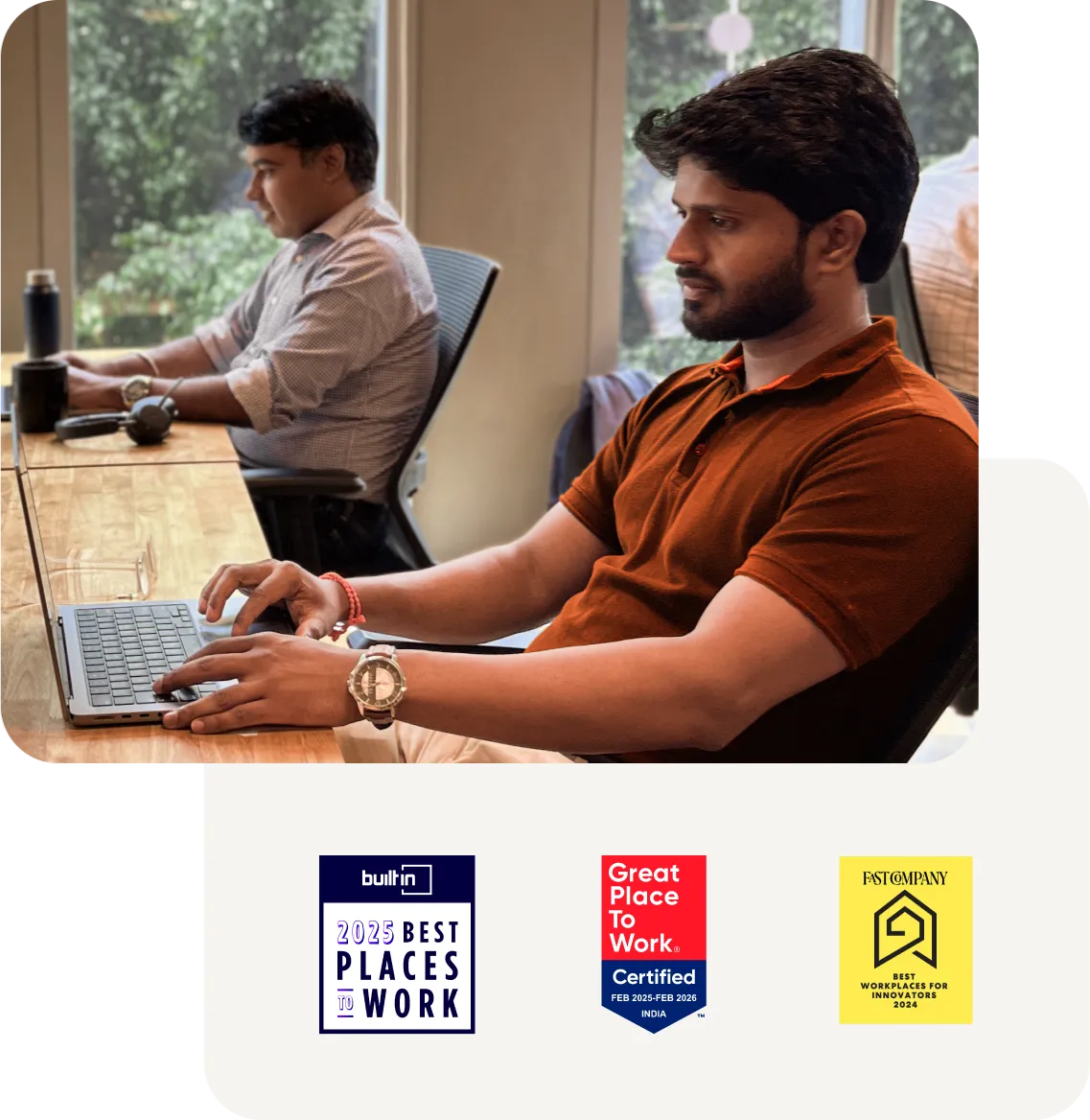 A man confidently working at his desk