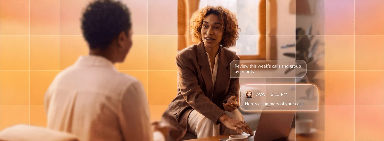 A professional discusses call summaries with a colleague using a laptop, showcasing RingCentral's team collaboration tools.