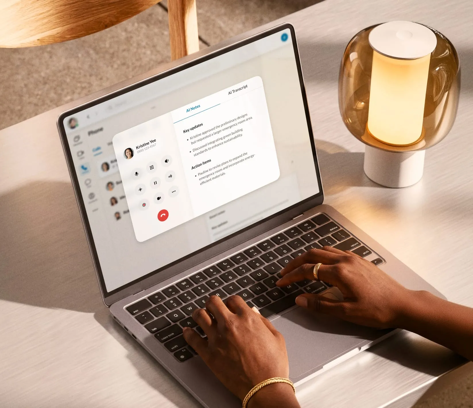 Person using a laptop with the RingCentral app, displaying a video call interface and AI transcript features.
