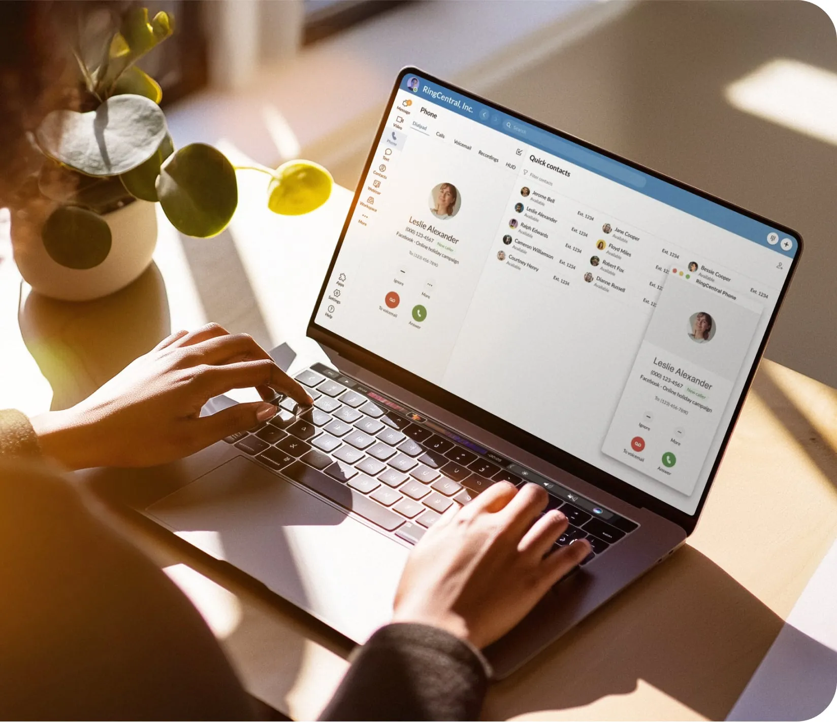 A pair of hands typing on a laptop