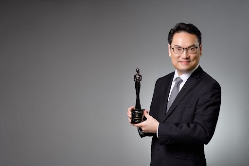 Marc Chan holds the award