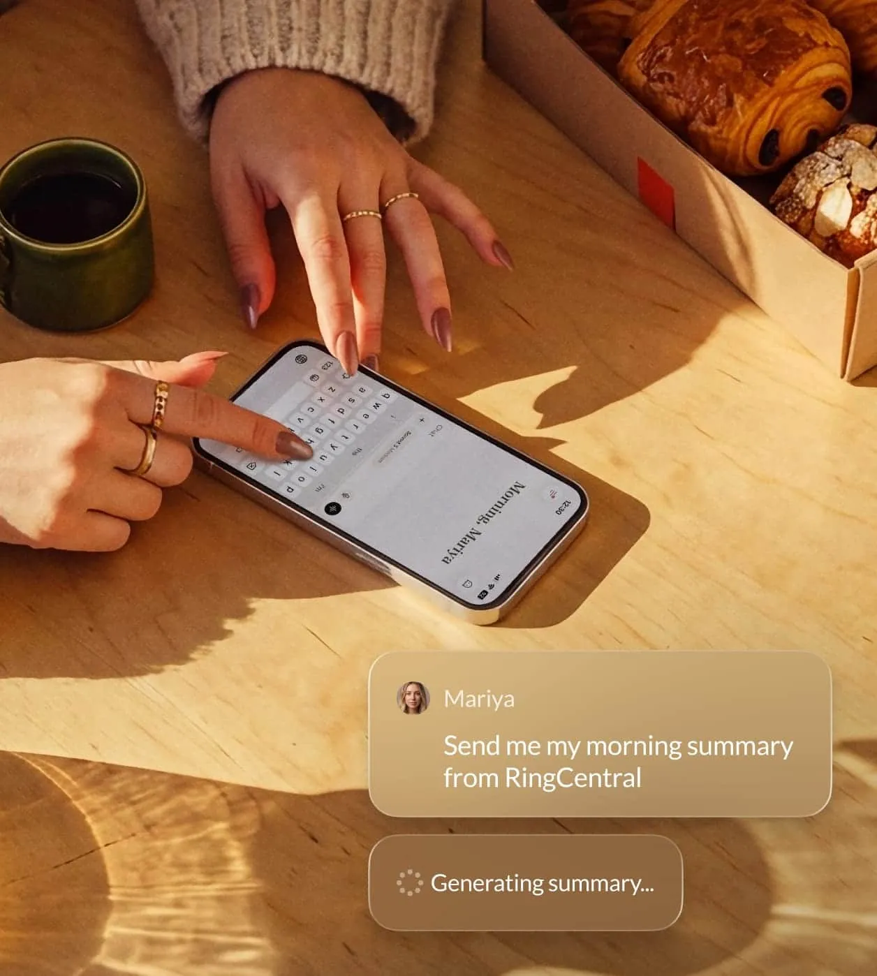 User interacting with a smartphone, generating a morning summary from RingCentral while enjoying coffee and pastries.