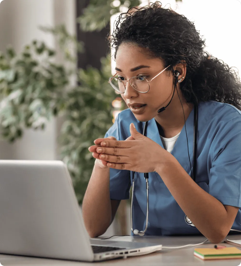A healthcare professional using RingCentral's integrated phone system to make calls on a laptop