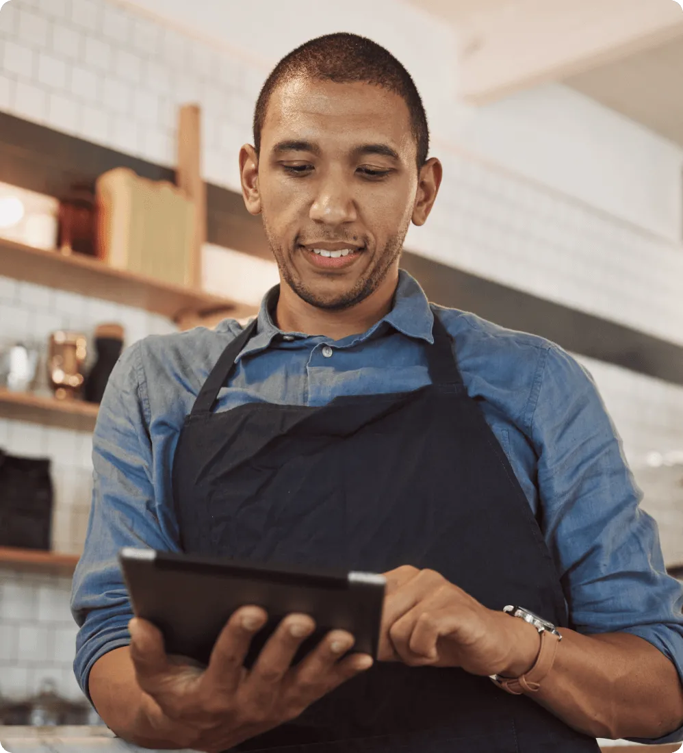 A male retail store employee taking orders from a tablet by using RingCentral's integrated business communications solution