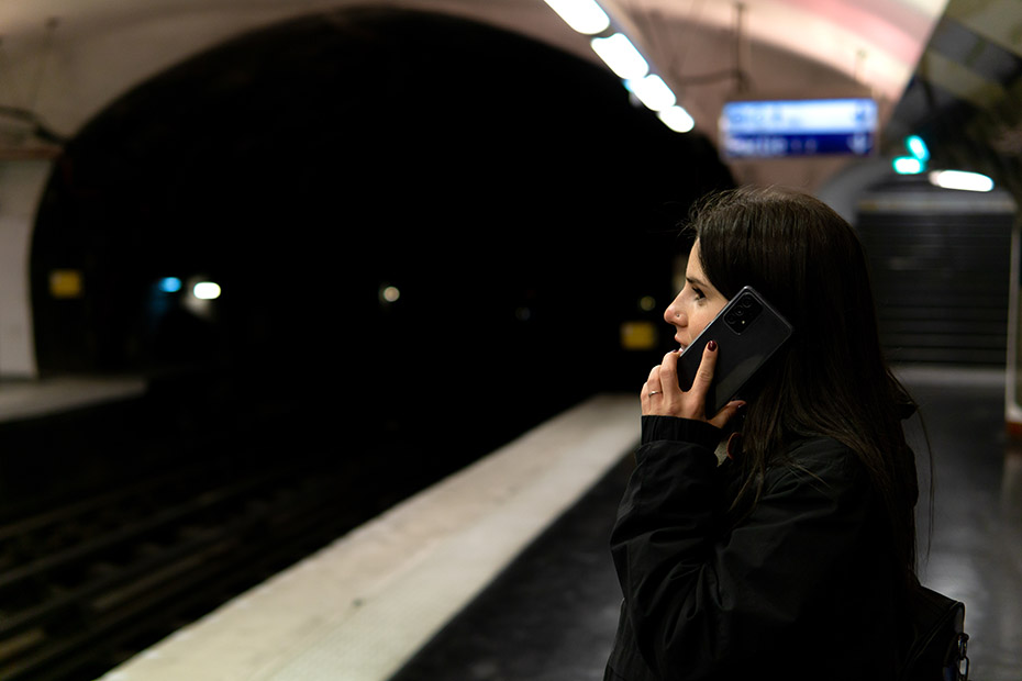 Femme au téléphone sur le quai du métro