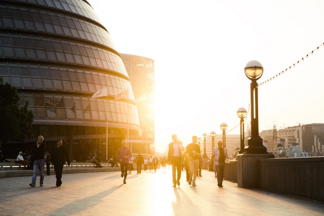 photo of People walking on the riverside next to london city hall