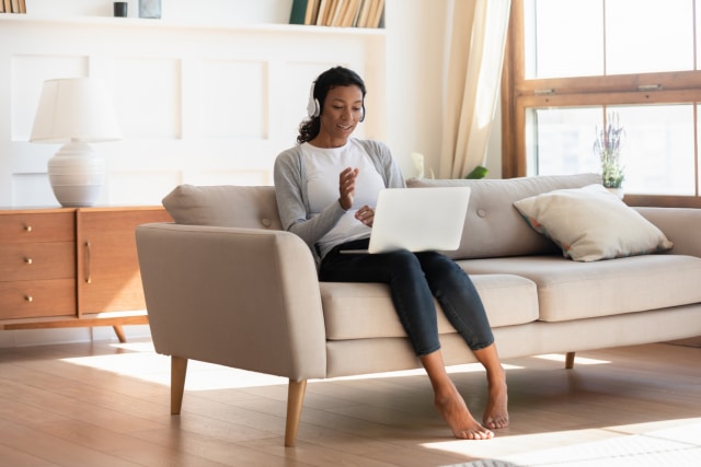 young biracial woman in headphones talk on video call