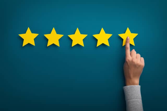 Woman hand showing on five star excellent rating | RingCentral UK