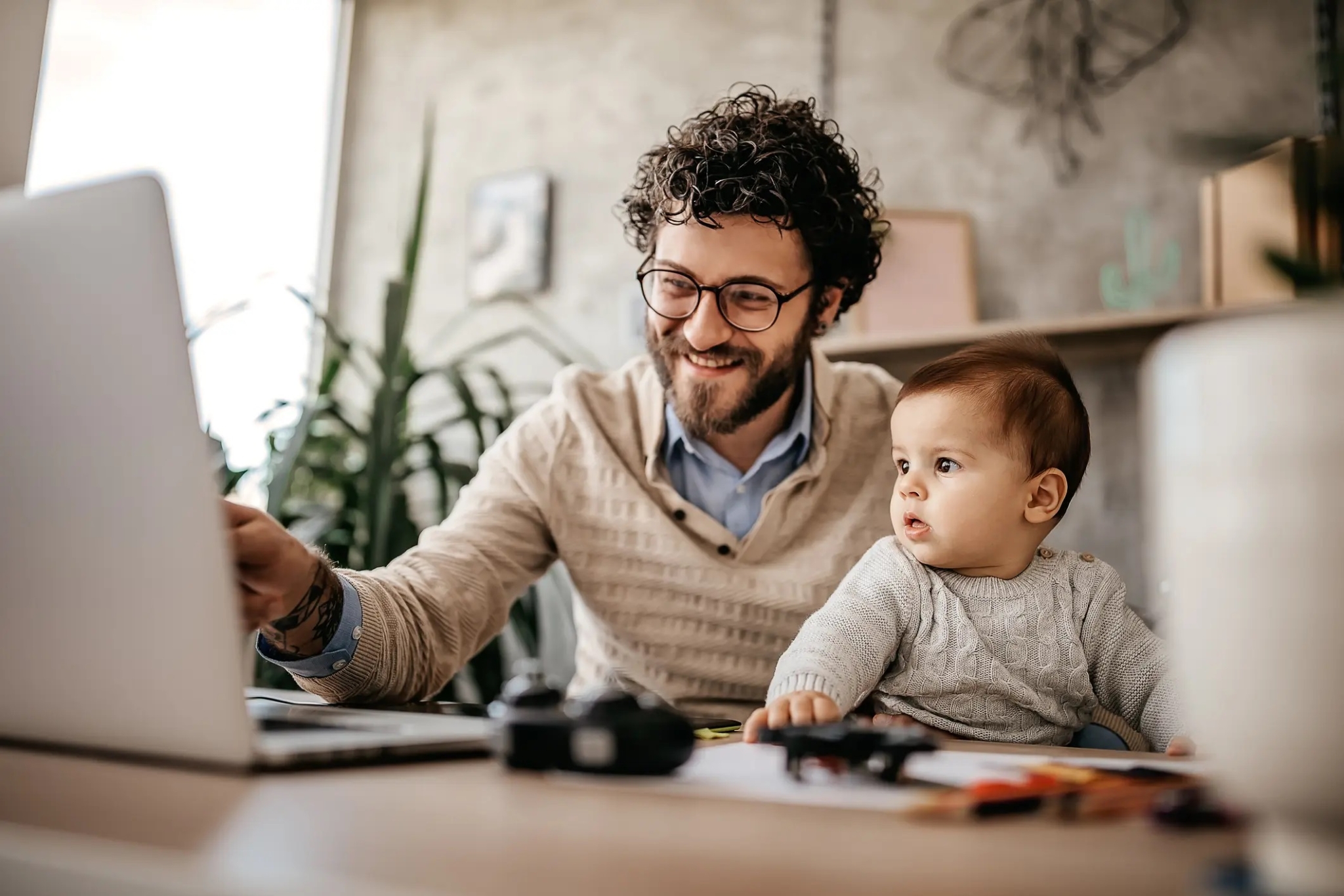 A man working from home while spending time with his son