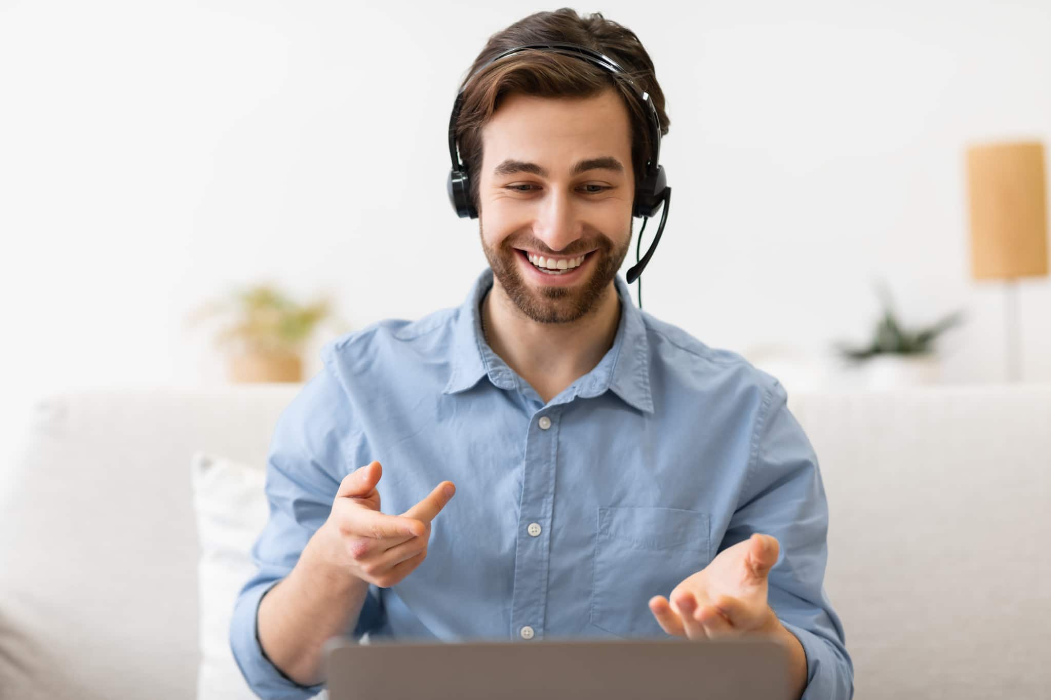 A person wearing headphones, speaking in a video call