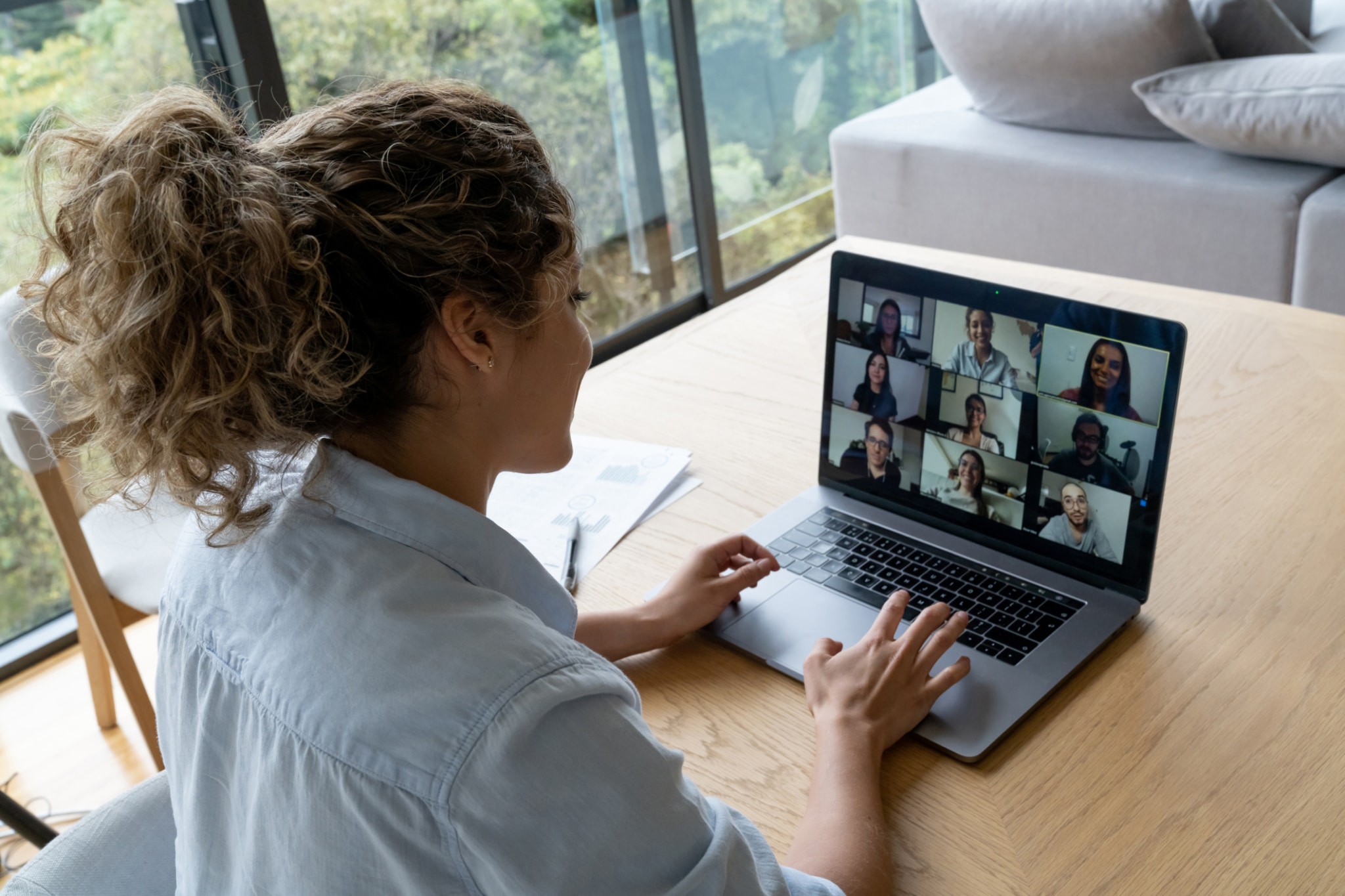 video conference with her coworkers while working from home