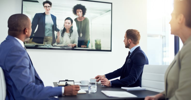 a diverse team of colleagues having a free conference call in a modern office