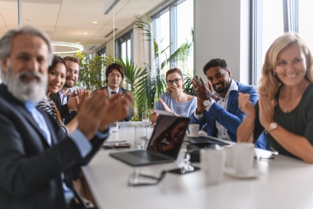 Smiling Executive Business Team Applauding Good News-878