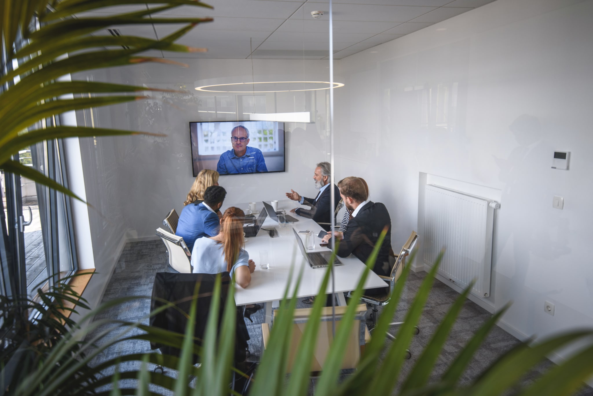 virtual conference with CEO in office board room