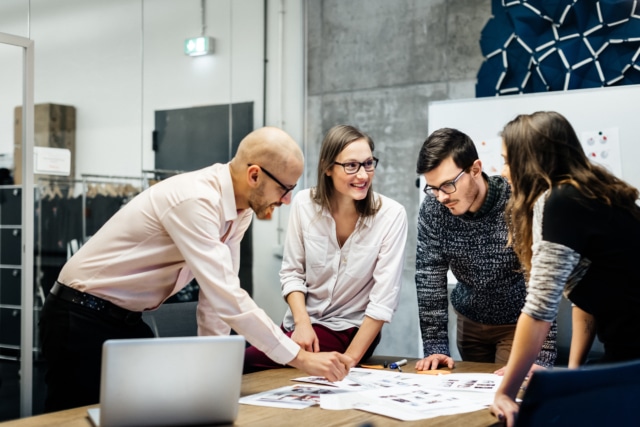 Team working ambitiously in an office room.-724