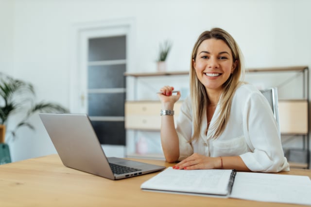 Portrait of a cheerful accountant at home office.-537