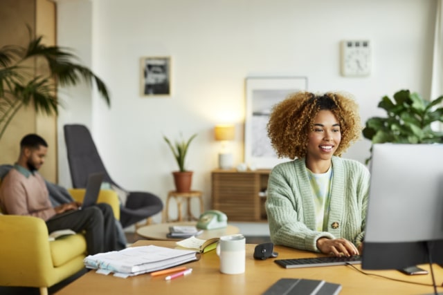Businesswoman Using Computer In Home Office-970