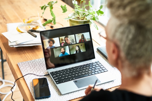 Woman having conversation to her team with video conference app