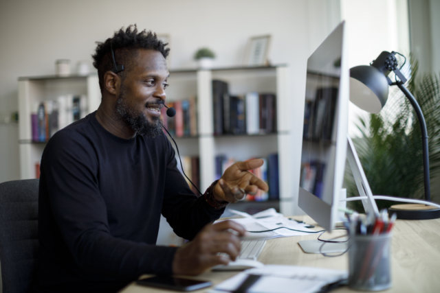 Smiling man with headset working from home-555