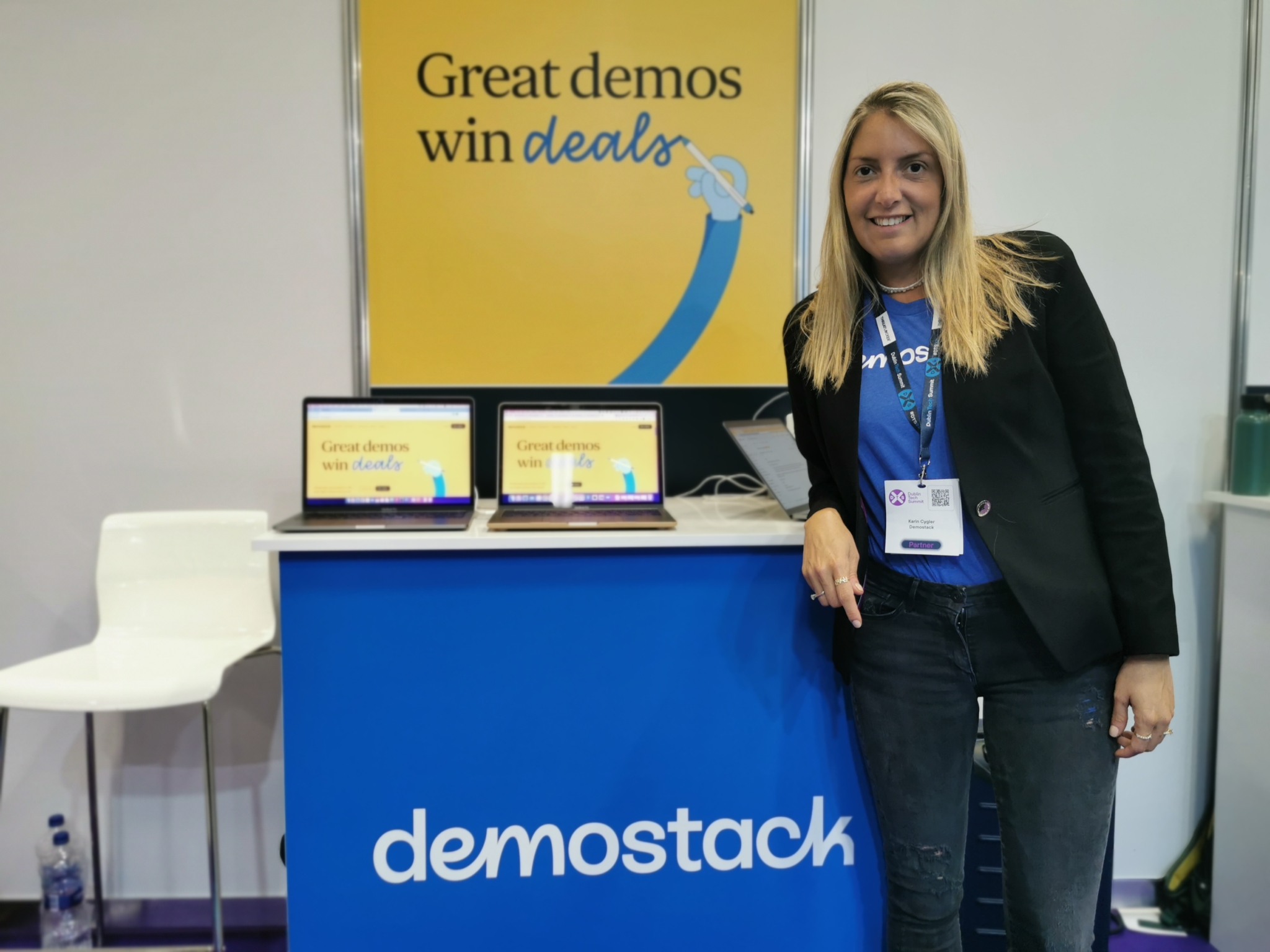 A woman stands at the demostack exhibitor stand at Dublin Tech Summit