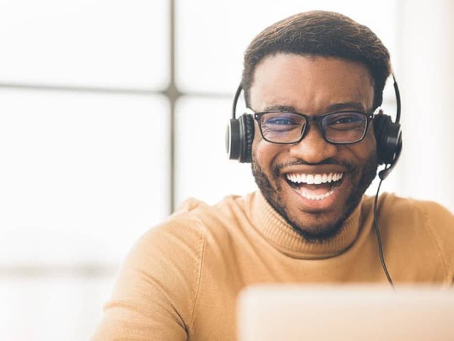 Smiling man talking with a headset