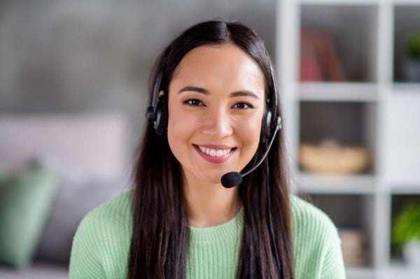 Woman smiling while wearing headset