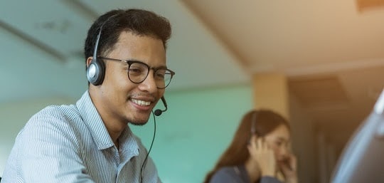 Smiling man wearing a headset