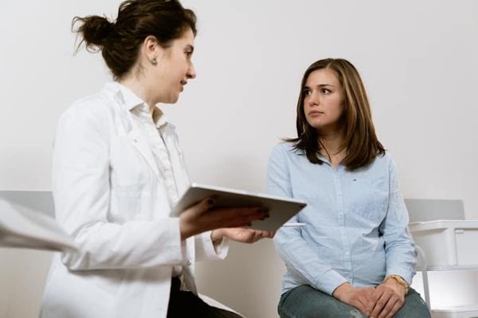 A doctor and a patient communicating in an examination room.