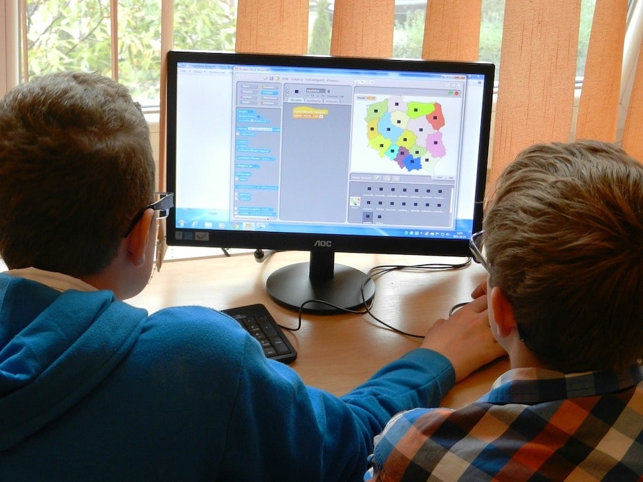 two students sitting in front of a computer for remote learning