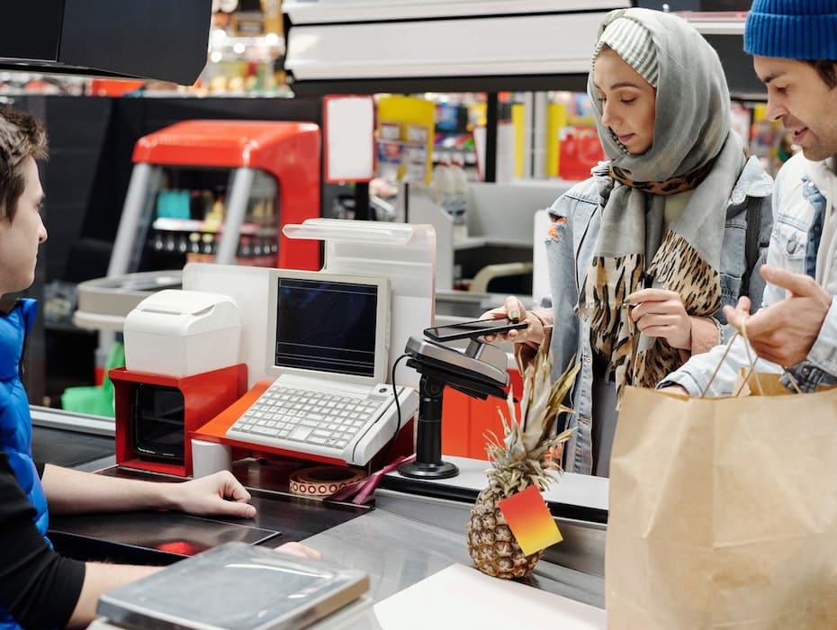 Customers standing in line waiting to pay a retail employee