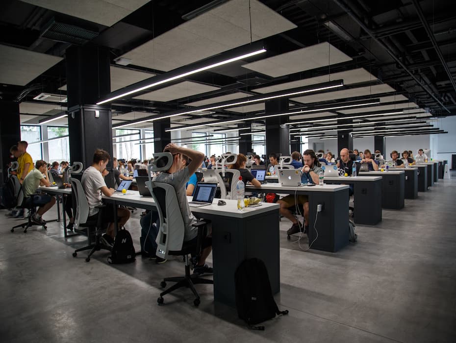 Image of workers, possibly editorial or contact center staff all concentrating in a modern loft style office.