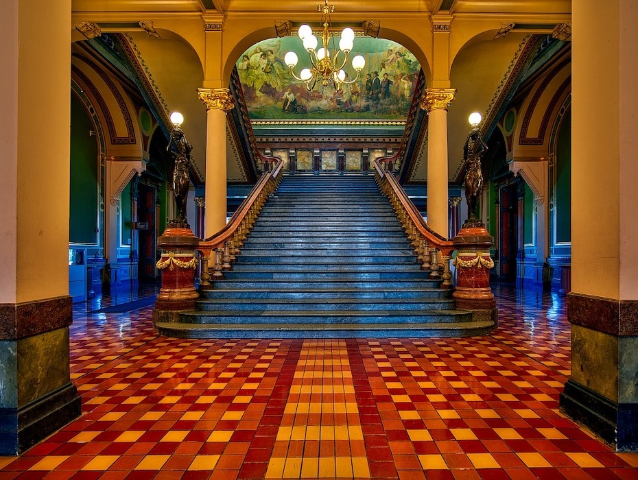 An impressive entrance and grand staircase within a government building
