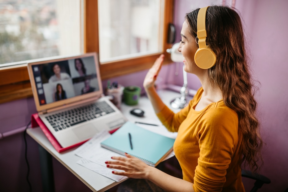 Woman studying at home with colleagues via video conference, demonstrating one of the benefits of video conferencing in education