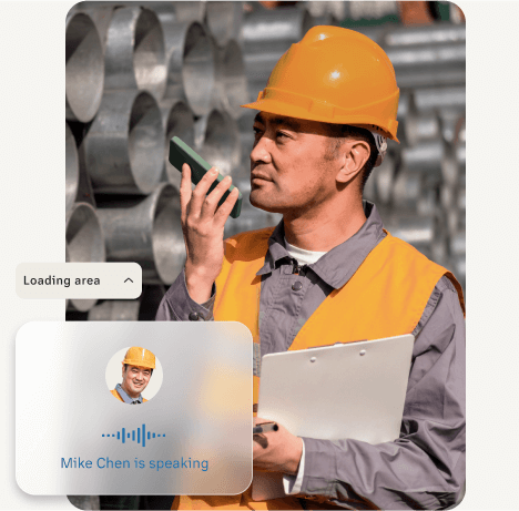 a man wearing a hard hat on a site uses RingCentral Push to Talk feature on a mobile phone