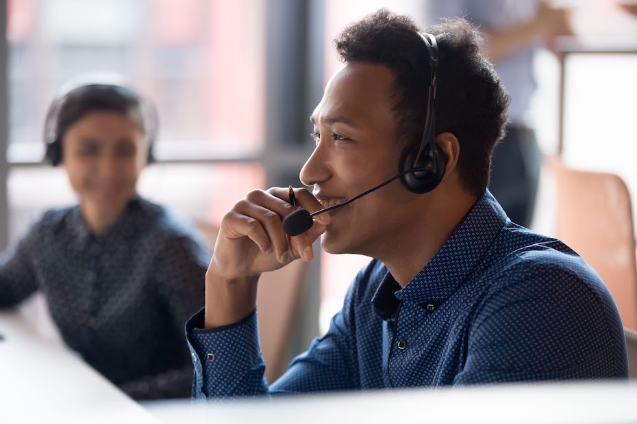 A customer service agent wears a headset while helping P&C Insurance clients.