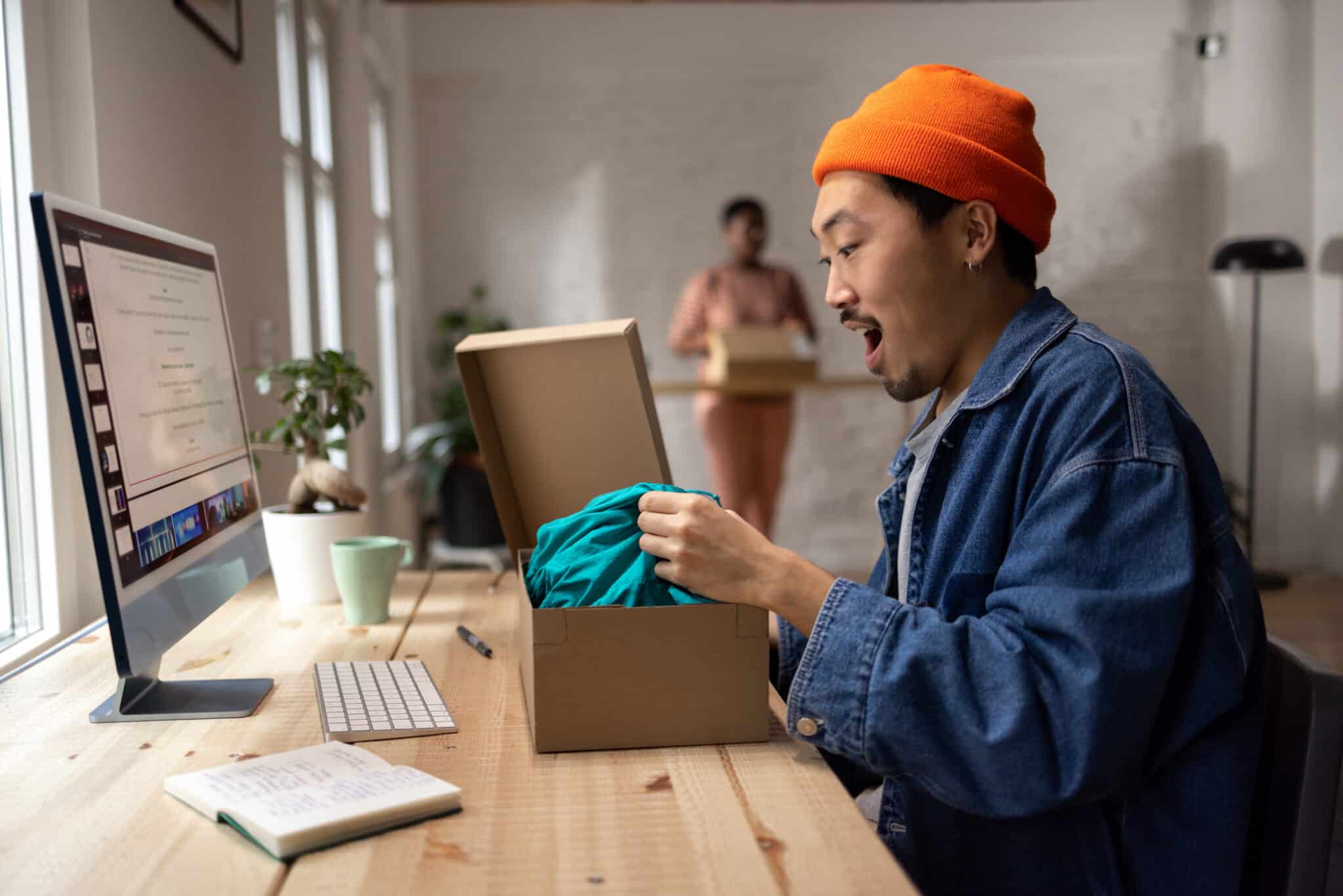 Young Asian man excited to receive his online order and open the package