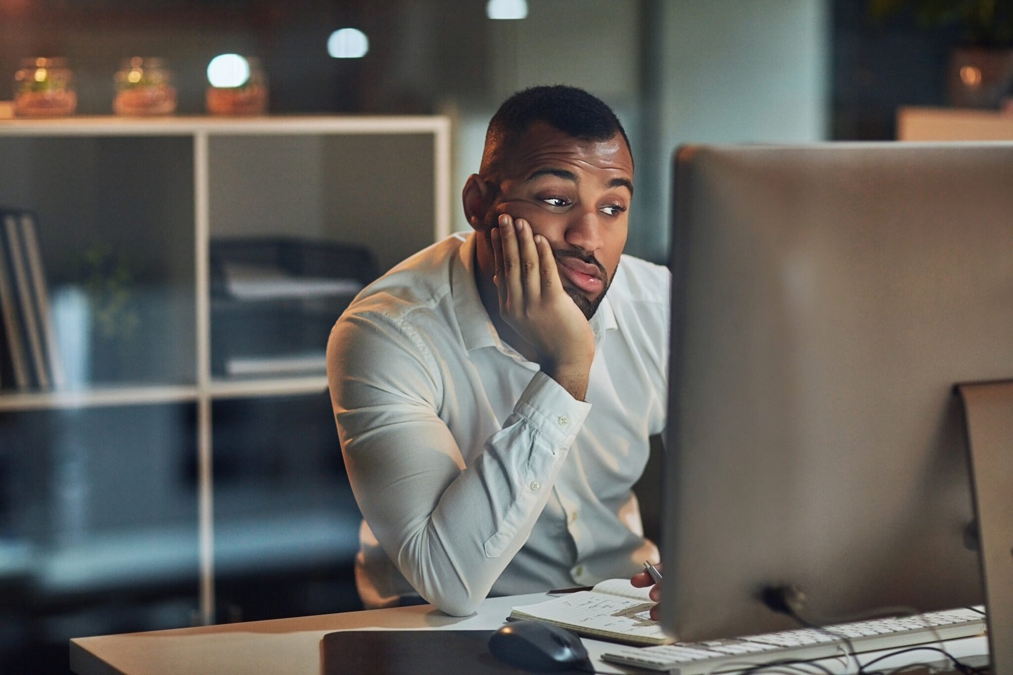 Meeting fatigue - man looking bored and tired in front of computer screen