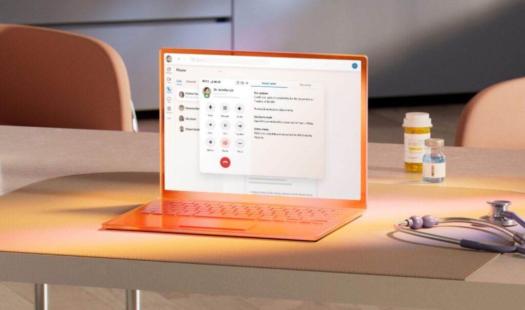 Laptop displaying healthcare call center software with live call controls on a desk beside prescription bottles and a stethoscope