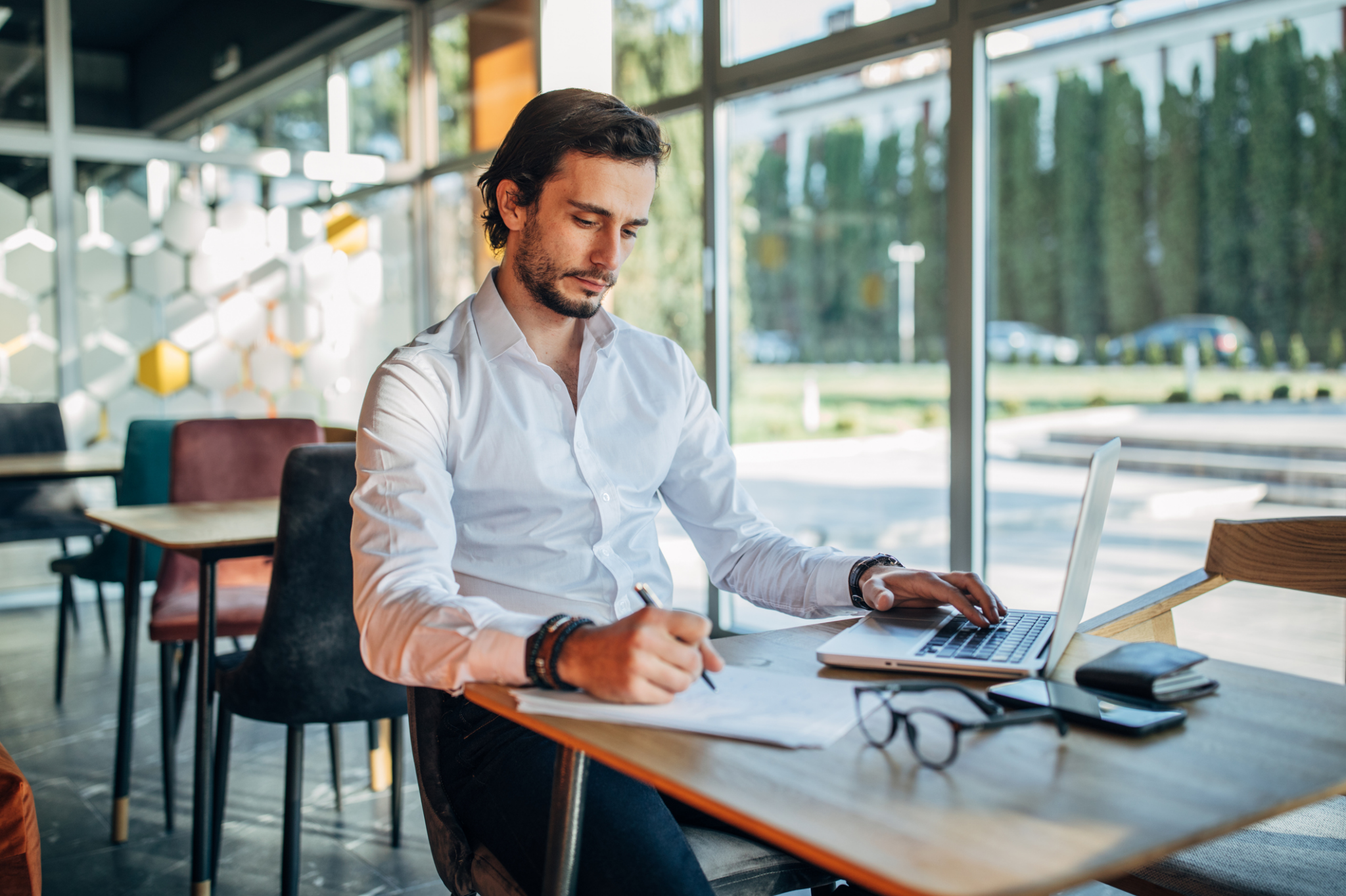 A financial services manager reviewing call insights and taking notes