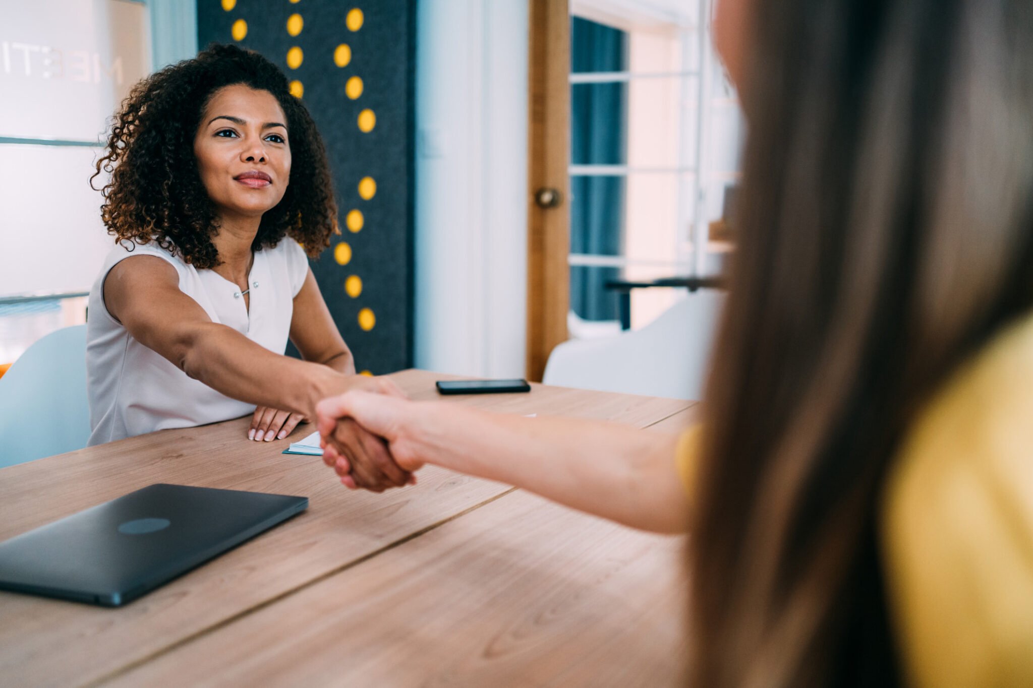 A customer shaking hands with a bank teller