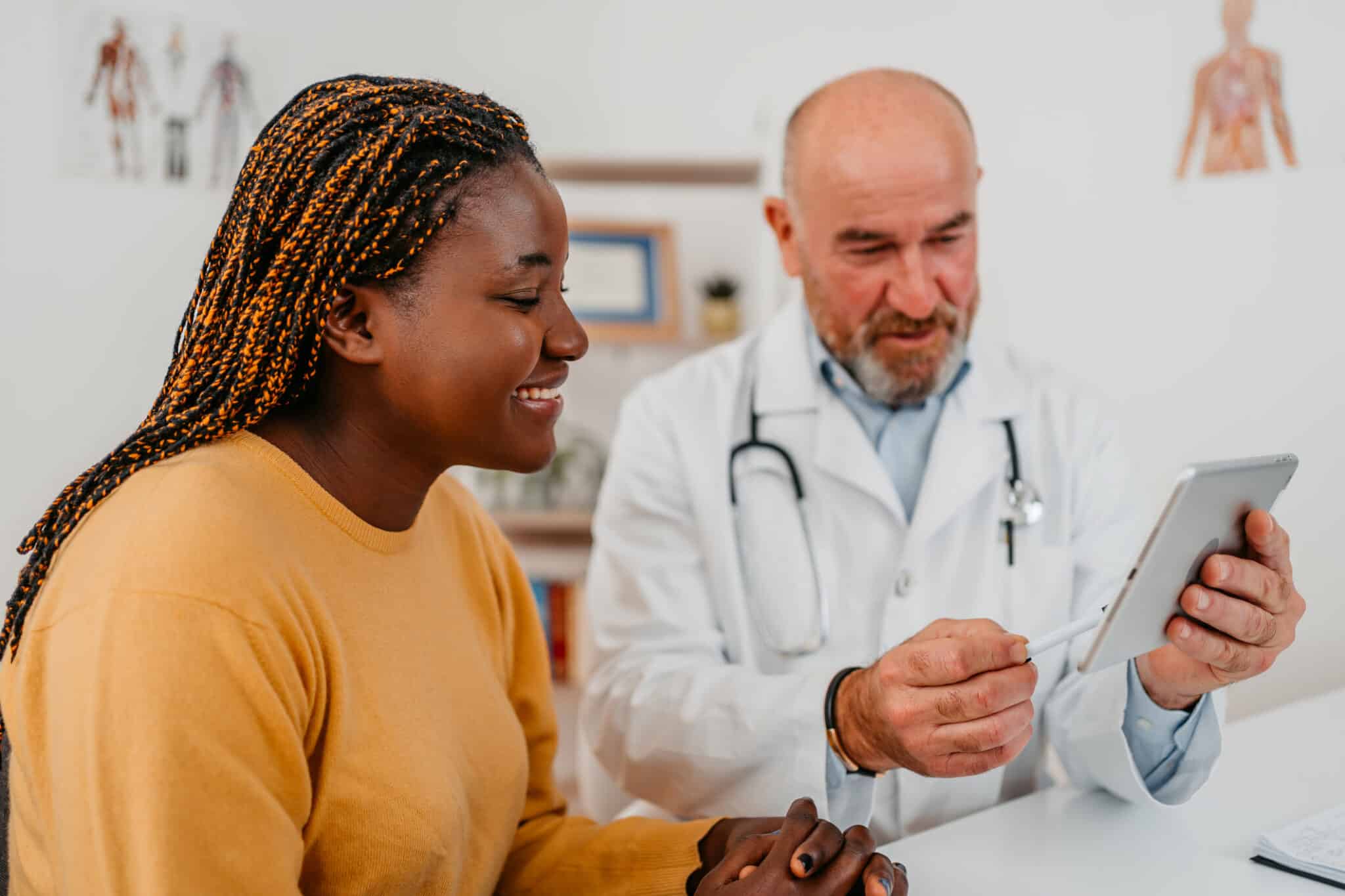 A doctor and a patient in discussion while looking at a tablet