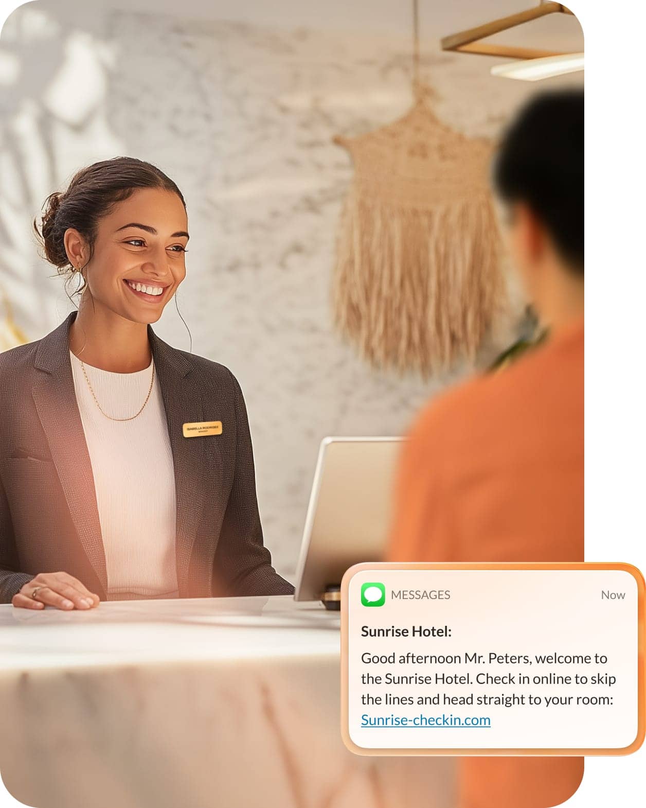 A front desk worker greets a customer while AI messages them with a hotel check-in link