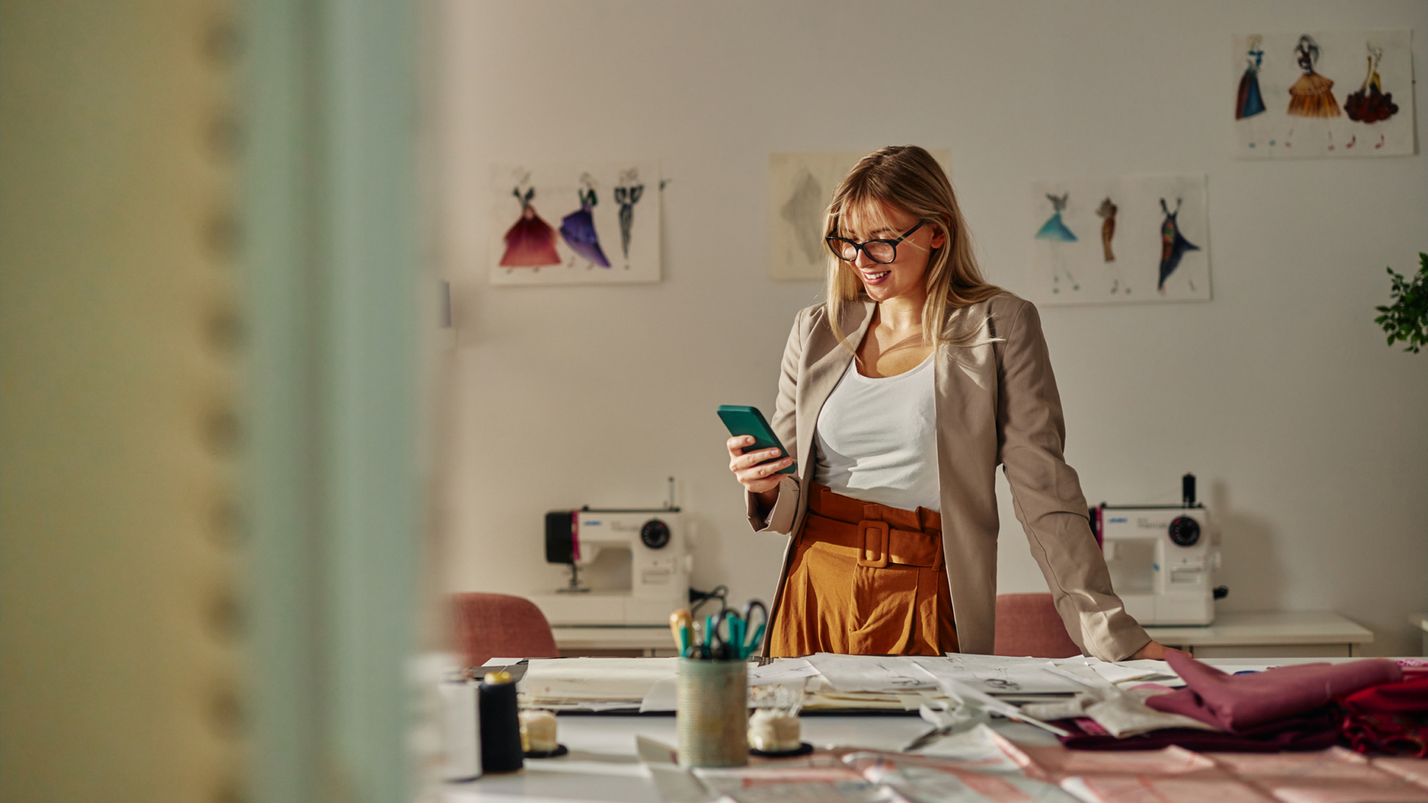 A retail manager looking at her phone in her office